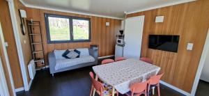 a living room with a table and chairs and a couch at Domaine Saône-Valley in Traves