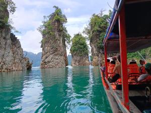 a group of people on a boat in a body of water at Khaosok Embrace Resort in Khao Sok National Park