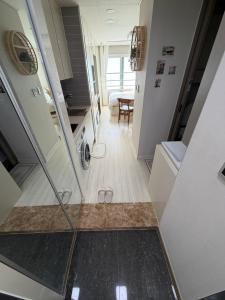 a hallway with a staircase with two shoes on the floor at 여유스테이 in Suwŏn-yŏk +97 photos