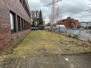 an empty alley next to a brick building at Boberger Hostel in Hamburg