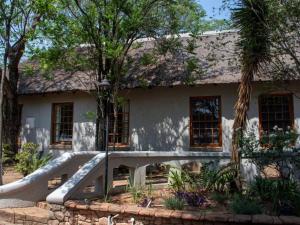 a house with a slide in front of it at Beverly Hills Lodge in Fourways