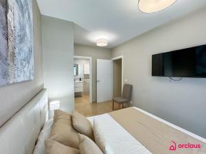 a bedroom with a bed and a flat screen tv at El Privilegio in Cabanes