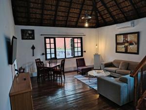 a living room with a couch and a table at Beverly Hills Lodge in Fourways