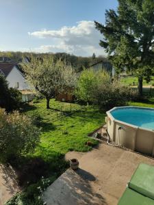 a backyard with a swimming pool in a yard at Au Jardin d'Isa in La Résie-Saint-Martin