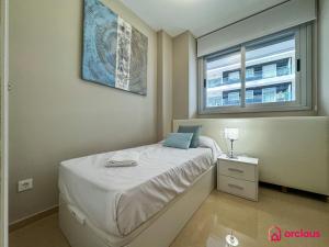 a small bedroom with a bed and a window at El Privilegio in Cabanes
