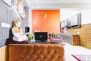a kitchen with a desk with a laptop on it at Nirvana Rooms - Shimla in Shimla