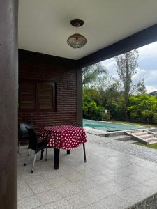 a table with a polka dot table cloth on a patio at casa cusi in Tafí Viejo