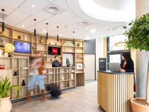 a lobby with people working at a counter in a store at ibis Marseille Centre Euromed in Marseille
