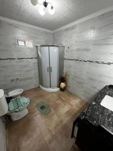 a bathroom with a shower and a toilet and a sink at casa cusi in Tafí Viejo +21 photos
