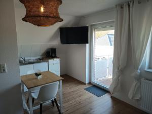 a small kitchen with a table and a window at Haus Lützowallee in Aurich