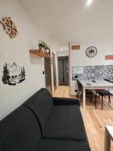 a living room with a couch and a table at Cier De Riviere "les Ours" in Cier-de-Rivière