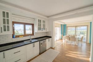 a kitchen with a sink and a dining room at Villa Everest in Dalaman +7 photos