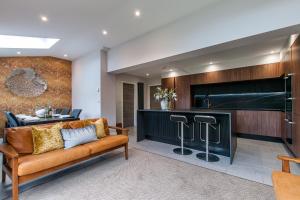 a living room with a couch and a bar at Luxury Beach Escape Pool Table & Private Parking in Broadstairs