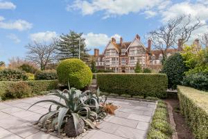 a house with a garden with bushes and trees at Luxury Beach Escape Pool Table & Private Parking in Broadstairs