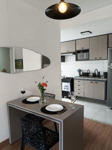 a kitchen with a table with two plates on it at Céu da Mantiqueira - Staffy House Extrema in Extrema