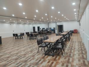a large room with tables and chairs in it at VMR Hotel Port Blair in Jangli Ghāt