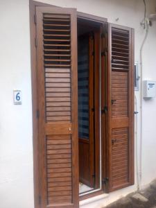 a wooden door with wooden shutters on a building at Casa Maria Naxos in Giardini Naxos