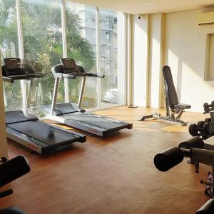 a gym with two treadmills and two exercise bikes at Nanay's Condotel in Sampong