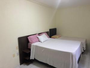 two beds sitting next to each other in a room at Condomínio Il Sole - apartamento 1 in Porto Seguro