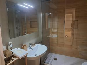 a bathroom with a white sink and a shower at Antica Dimora Petito Luxury in Matera +50 photos