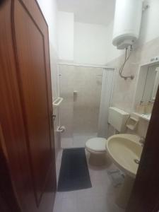 a bathroom with a toilet and a sink at Casa Maria Naxos in Giardini Naxos