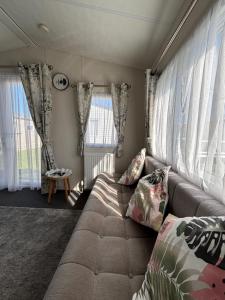 a living room with a couch and some windows at Seaview Holiday Rentals in Whitstable +20 photos