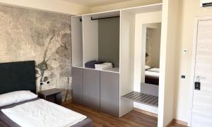a bedroom with a bed and a closet at Hotel Alesi in Malcesine +51 photos