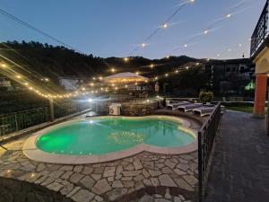 a swimming pool at night with lights around it at Villa Paola - Cinque Terre unica! pool e AC! in Pignone