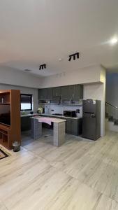 a large kitchen with a counter top in a room at شالية موج 335 in Dhahran