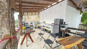 a kitchen with chairs and a table and a refrigerator at HOTEL SOÍ BACALAR in Bacalar