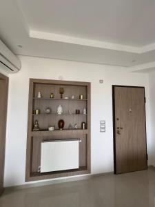 a room with a wooden door and a shelf at Apartment with sea view and pool access in Chott Meriem +35 photos