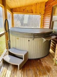 a sauna with a bench on a wooden deck at Connie's Little House in Elmira