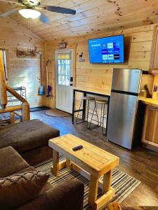 a living room with a refrigerator and a table at The Buck Shack in Elmira