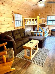 a living room with a couch and a table in a cabin at The Buck Shack in Elmira +19 photos