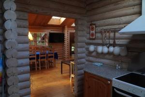 a kitchen and dining room in a log cabin at The Log Cabin in Hadsund