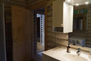a bathroom with a sink and a mirror at The Log Cabin in Hadsund +22 photos