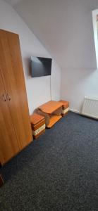 a room with a wooden cabinet and a desk at Pensiune Urban in Borsec