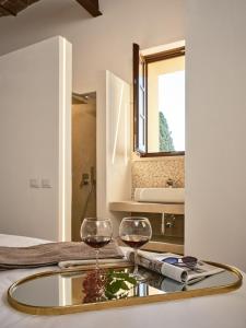 two glasses of wine on a table in a bathroom at Villa Eos in Chiusure +62 photos
