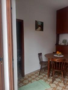a kitchen with a table and a dining room at Casa Maria Naxos in Giardini Naxos +6 photos