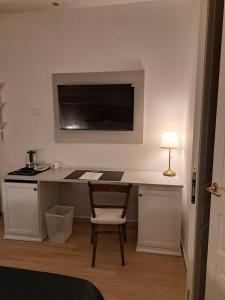 a room with a desk with a chair and a lamp at Antica Dimora Petito Luxury in Matera