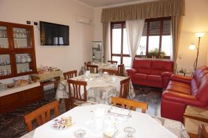 a living room with two tables and a couch at B&B Piazza 300mila in Lecce