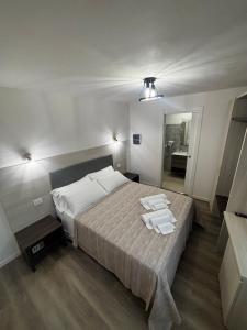 a bedroom with a bed with two towels on it at I due archi in Norcia