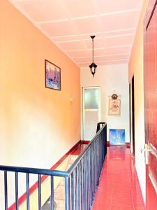 a hallway with a staircase with a blue railing at Laa Villa Kandy in Kandy