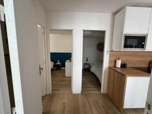 a kitchen and a living room with a bedroom at la capeline in Chablis