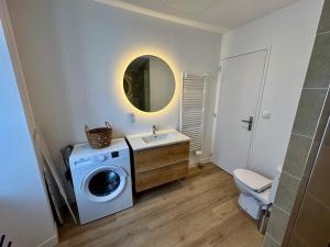 a bathroom with a washing machine and a sink at la capeline in Chablis +57 photos