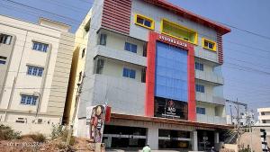 a large building with a red white and blue at Hotel MEGA International Airport Zone in Hyderabad