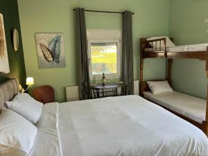 a bedroom with two bunk beds and a window at Akrotiri Studios in Samothraki