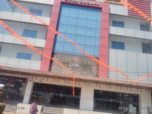 a building with orangebons around the front of it at Hotel MEGA International Airport Zone in Hyderabad +3 photos