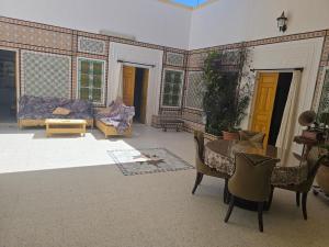 a living room with a couch and a table at Dar lel khedija in Mahdia