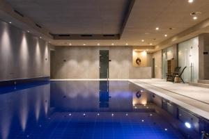 a swimming pool in a building with a pool at Apartmány U stezek in Lipova Lazne